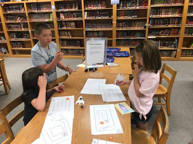 Students working on a hands-on STEM activity at a library workshop