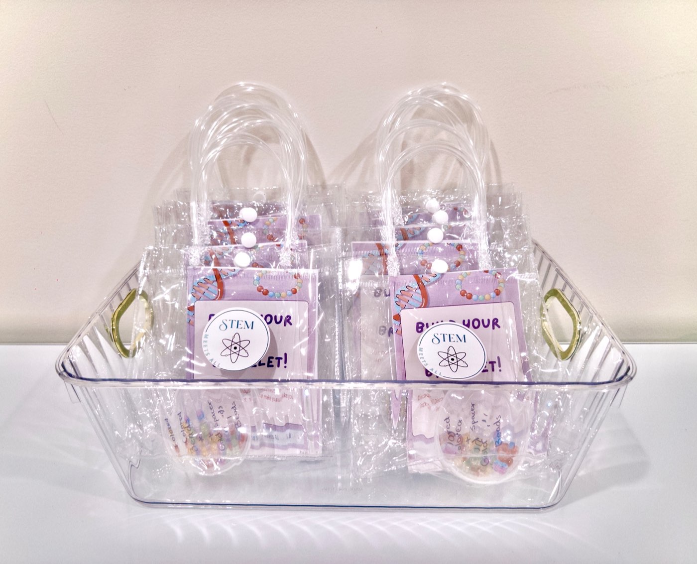 A basket of packaged STEM Meets All DNA bracelet kits