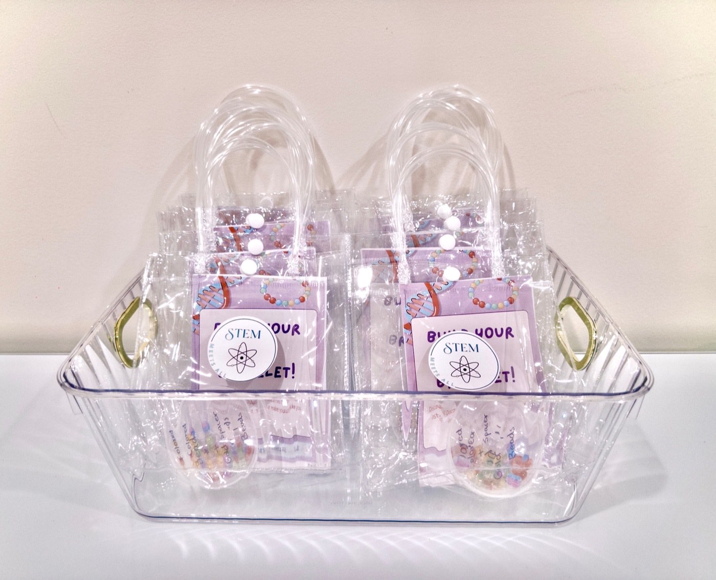 A basket of packaged STEM Meets All DNA bracelet kits