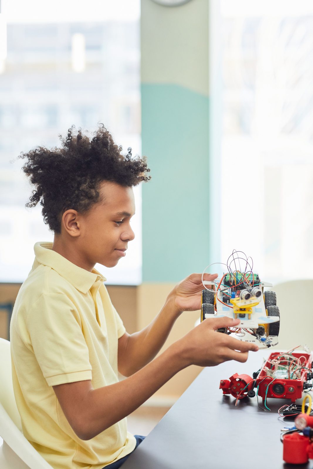 A student working hands-on with a robotics kit
