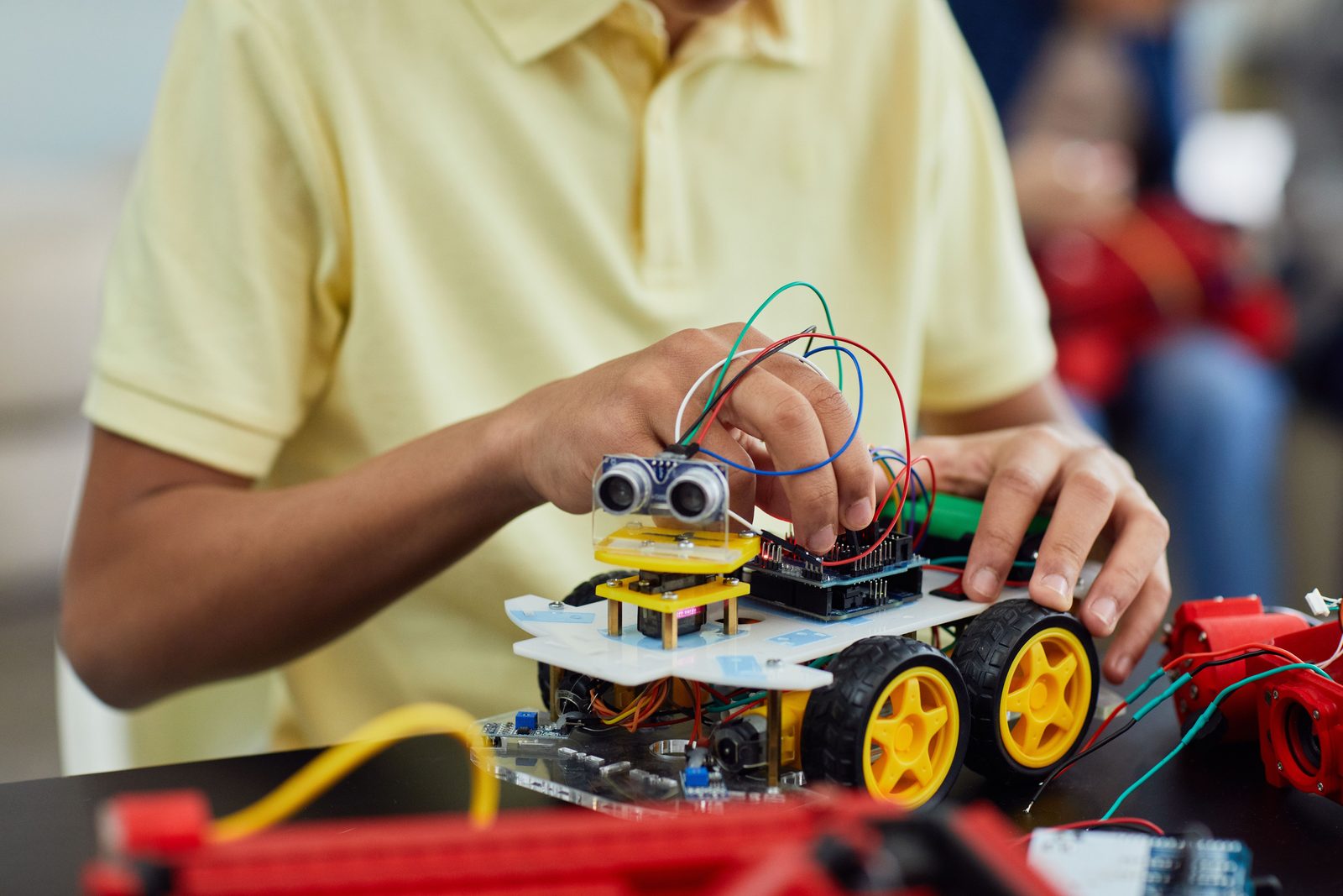 A student wiring a hands-on robotics kit