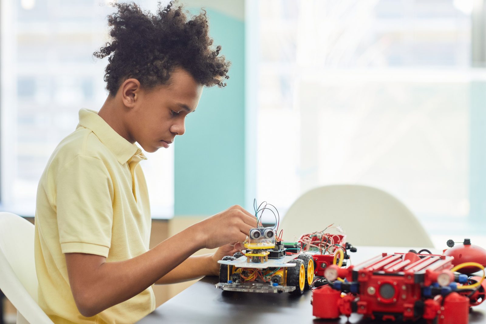 A student focused on building a robotics kit